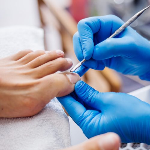 pedicure-process-home-salon-pedicure-foot-care-treatment-nail-process-professional-pedicures-master-blue-gloves-make-pedicure (1)